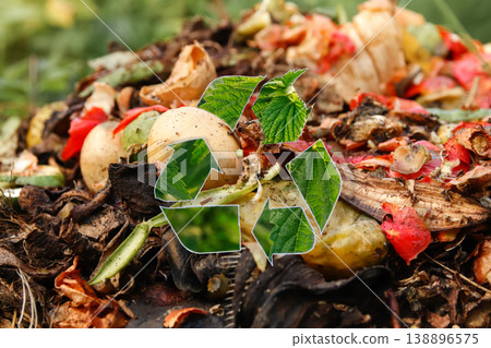 green recycling symbol on organic compost pile background. Food waste recycling, zero waste, and environmental protection concept. Sustainable organic compost and rich soil for garden care green recycling symbol on organic compost pile background. Food waste recycling, zero waste, and environmental protection concept. Sustainable organic compost and rich soil for garden care 138896575