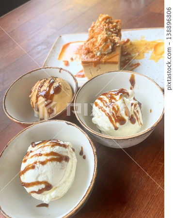 A dessert set featuring three flavors of ice cream and a rich caramel cake. A dessert set featuring three flavors of ice cream and a rich caramel cake. 138896806