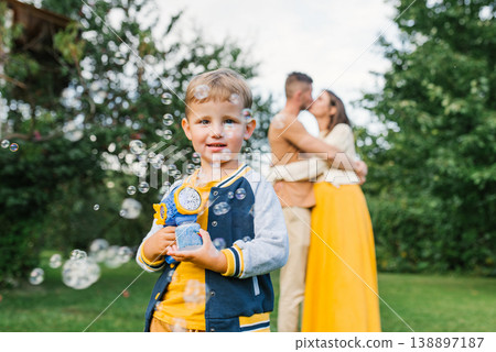 Little Boy Playing With Soap Bubbles Outdoors Little Boy Playing With Soap Bubbles Outdoors 138897187