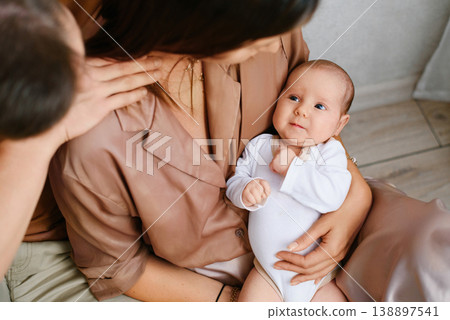 Cute Newborn Baby Lying In Mothers Arms Cute Newborn Baby Lying In Mothers Arms 138897541