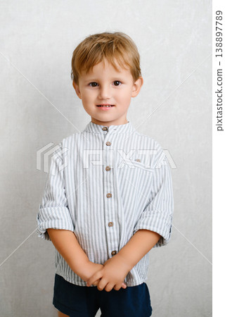 Smiling Boy In Striped Shirt Indoors Smiling Boy In Striped Shirt Indoors 138897789