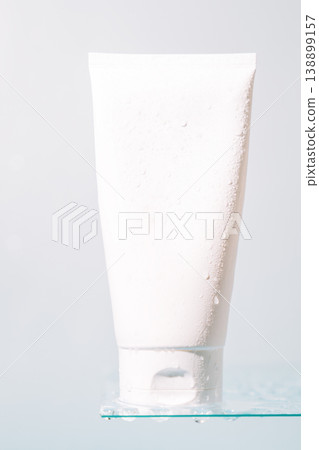 White cosmetic tube on glass shelf with copy space 138899157