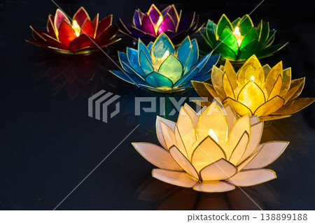 Vesak day. Colorful glowing lotus flower candle holders floating 138899188