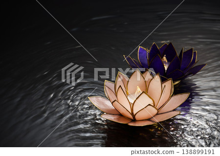 Vesak day. Glowing lotus candles floating on rippled water Vesak day. Glowing lotus candles floating on rippled water 138899191