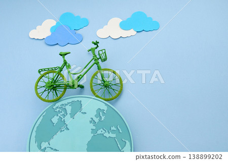 World bicycle day. Green bicycle miniature on earth globe, eco transportation concept World bicycle day. Green bicycle miniature on earth globe, eco transportation concept 138899202