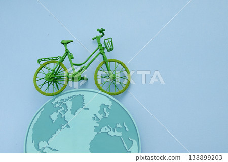 World bicycle day. Green bicycle riding on planet earth for sustainability World bicycle day. Green bicycle riding on planet earth for sustainability 138899203
