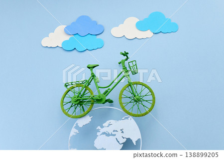 World bicycle day. Green bicycle on earth globe promoting eco transportation World bicycle day. Green bicycle on earth globe promoting eco transportation 138899205