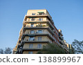 Corner residential apartment building with balconies under clear blue sky in Barcelona Spain 138899967