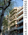 Residential apartment building with balconies and trees in sunny street in Barcelona Spain 138899968