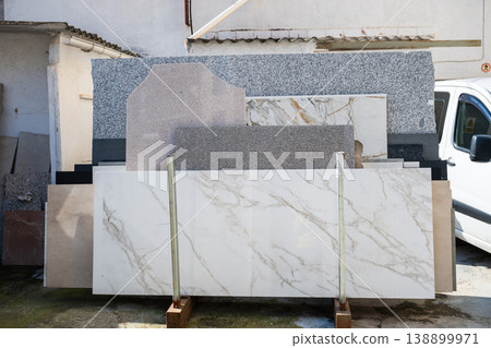 Marble and granite stone slabs display in outdoor construction materials yard 138899971