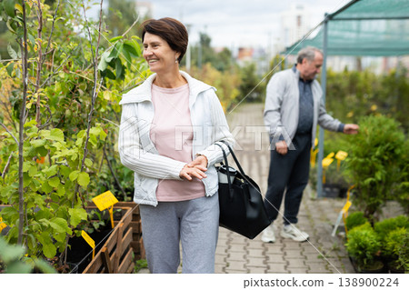 man and woman buy tree seedlings at an open market man and woman buy tree seedlings at an open market 138900224