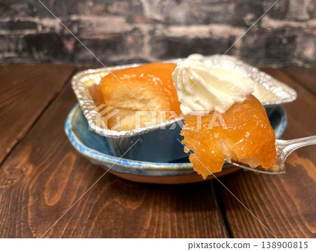 Savarin cake - A rum-infused pastry scooped with a spoon - another angle Savarin cake - A rum-infused pastry scooped with a spoon - another angle 138900815