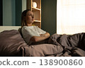 Woman lying awake in bed at night, feeling frustrated and stressed due to a sleep disorder or difficulty falling asleep, indicating an issue with rest and a disturbed circadian rhythm 138900860