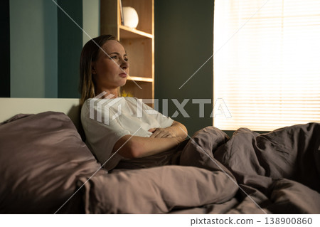 Woman lying awake in bed at night, feeling frustrated and stressed due to a sleep disorder or difficulty falling asleep, indicating an issue with rest and a disturbed circadian rhythm Woman lying awake in bed at night, feeling frustrated and stressed due to a sleep disorder or difficulty falling asleep, indicating an issue with rest and a disturbed circadian rhythm 138900860