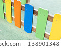 Multicoloured wooden fence on a children playground. 138901348