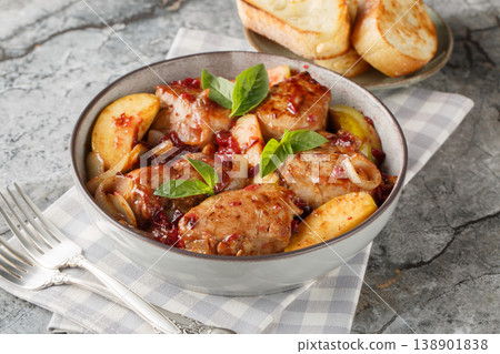 Close-up of seared and then braised pork tenderloin with caramelized onions, cranberry sauce and green apples in a bowl. Horizontal Close-up of seared and then braised pork tenderloin with caramelized onions, cranberry sauce and green apples in a bowl. Horizontal 138901838