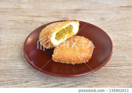 donut bread filling chicken curry half cut on plate 138902011