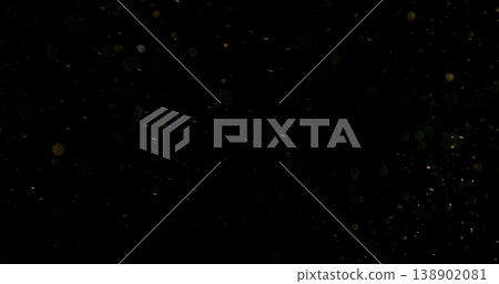 Close-up of floating dust particles in air, isolated on black background. Minimalist abstract texture with soft light, designed as VFX overlay for compositing. Close-up of floating dust particles in air, isolated on black background. Minimalist abstract texture with soft light, designed as VFX overlay for compositing. 138902081