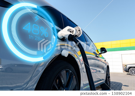 Electric car reaches 48 percent charge while connected to charging station in bright daylight Electric car reaches 48 percent charge while connected to charging station in bright daylight 138902104