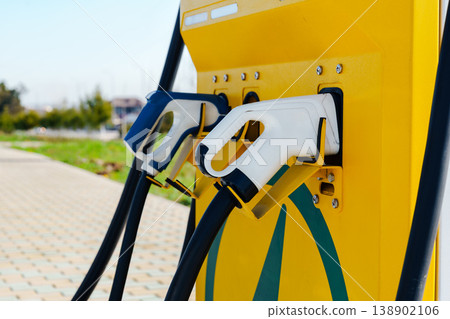 Electric car charger setup at public station for convenient charging in urban area 138902106