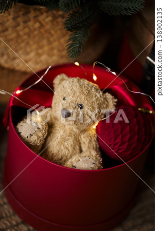 Vintage Christmas decor with red chest decorative drum and toys on jute rug in cozy interior Vintage Christmas decor with red chest decorative drum and toys on jute rug in cozy interior 138902135