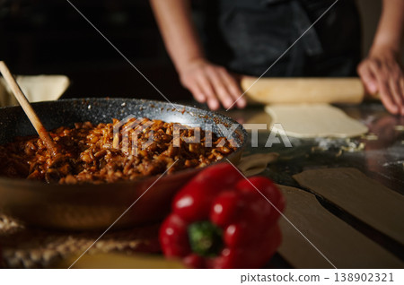 Home Cooking With Rolling Pin and Savory Skillet Filling on Pastry Dough Home Cooking With Rolling Pin and Savory Skillet Filling on Pastry Dough 138902321