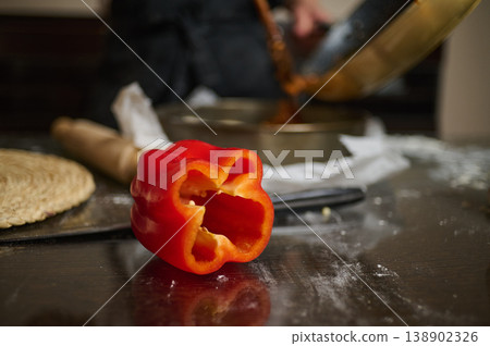 Red Bell Pepper on Kitchen Countertop with Rolling Pin and Bowl During Food Preparation 138902326