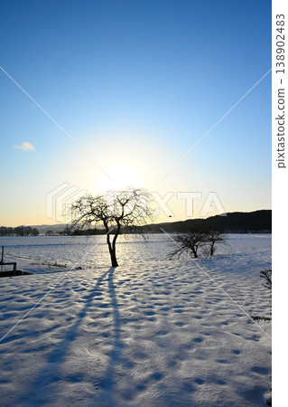 Snow-covered land silhouetted against the setting sun (Inawashiro Town, Fukushima Prefecture) Snow-covered land silhouetted against the setting sun (Inawashiro Town, Fukushima Prefecture) 138902483