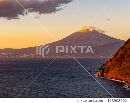 Mount Fuji illuminated by the setting sun, viewed from West Izu in late autumn. Mount Fuji illuminated by the setting sun, viewed from West Izu in late autumn. 138902862
