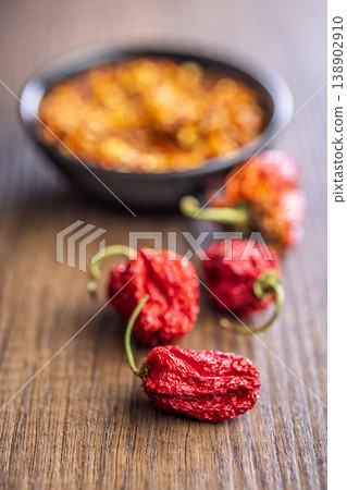Dried Red Chili Peppers With Crushed Red Pepper Flakes On Wooden Surface, Spicy Seasoning Dried Red Chili Peppers With Crushed Red Pepper Flakes On Wooden Surface, Spicy Seasoning 138902910