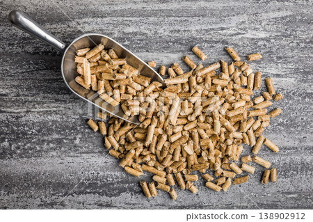 Wood Pellets With Metal Scoop On Concrete Surface For Biomass Fuel And Heating Use 138902912