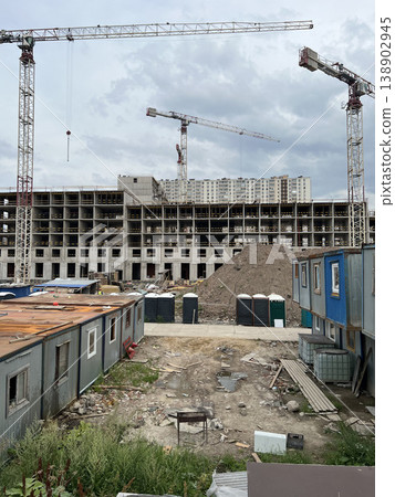 Construction Site with Temporary Worker Trailers and Tower Crane 138902945