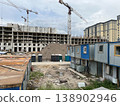 Multi-Story Apartment Construction Surrounded by Contractor Trailers and Equipment 138902946