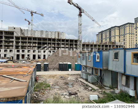 Multi-Story Apartment Construction Surrounded by Contractor Trailers and Equipment Multi-Story Apartment Construction Surrounded by Contractor Trailers and Equipment 138902946