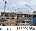 High-Rise Building Under Construction Featuring Site Cabins and Lifting Crane 138902950