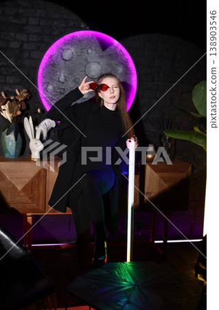 Music producer in sleek attire under vibrant nighttime illumination Music producer in sleek attire under vibrant nighttime illumination 138903546