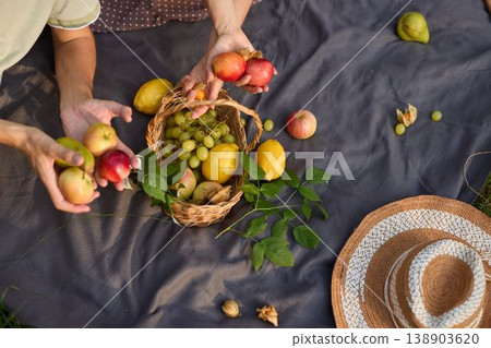 Peaceful picnic scene with fresh fruit under evening light Peaceful picnic scene with fresh fruit under evening light 138903620