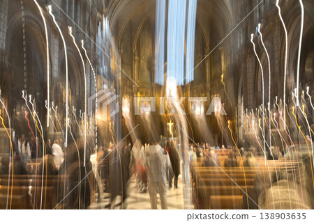 Abstract motion blur captures the ethereal glow of lights and indistinct figures within a grand cathedral setting Abstract motion blur captures the ethereal glow of lights and indistinct figures within a grand cathedral setting 138903635