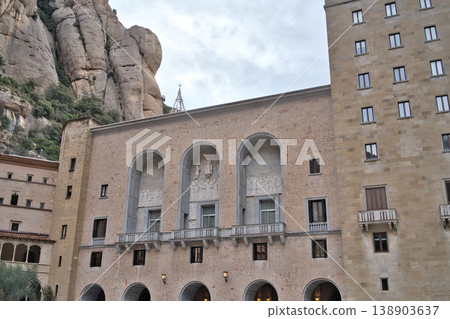 The historic Montserrat Monastery complex showcases impressive stone architecture nestled against dramatic mountain cliffs under, Barcelona, Spain, 2026-01-02 138903637