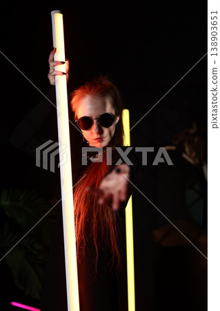 Immersive installation featuring strikingly styled neon performer 138903651