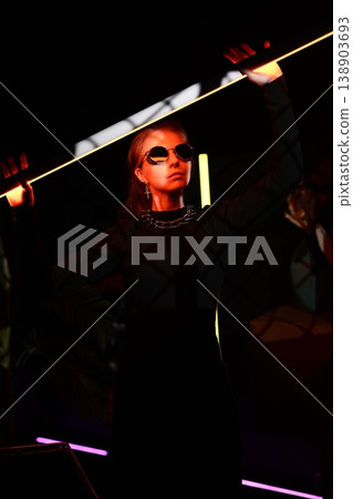 Cinematic portrayal of club goer with reflective eyewear Cinematic portrayal of club goer with reflective eyewear 138903693