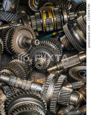 Close-up of metal gears and shafts in industrial setting 138904796