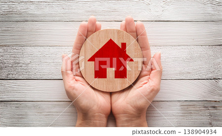 Protecting Home: Symbolic Hands Holding a House Icon Protecting Home: Symbolic Hands Holding a House Icon 138904934