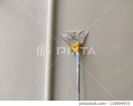 Worker tool scraping wall for repair indoors Worker tool scraping wall for repair indoors 138904953