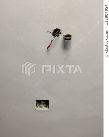 Ceiling fan mount frame with exposed wire and wrong hole showing poor electrical work 138904954