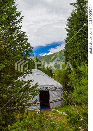 Traditional Kyrgyz yurt along serene pathway in mountains of Kyrgyzstan at summer day 138905044