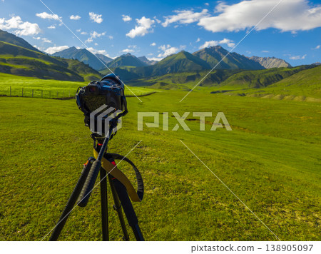 Serene mountain landscape with meadow and clouds in Kyrgyzstan 138905097