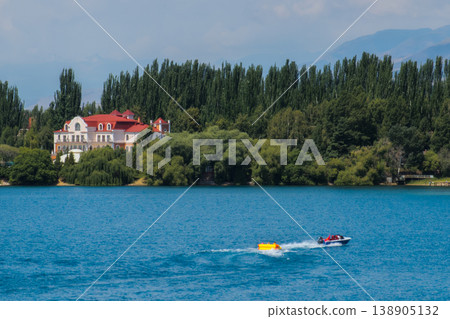 Three adults enjoying recreation on lake in motorboat Three adults enjoying recreation on lake in motorboat 138905132