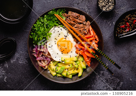 Traditional Korean dish Bibimbap: rice with vegetables beef and egg. Traditional Korean dish Bibimbap: rice with vegetables beef and egg. 138905216