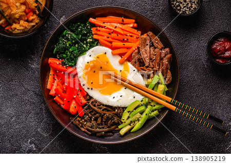 Traditional Korean dish Bibimbap: rice with vegetables beef and egg. Traditional Korean dish Bibimbap: rice with vegetables beef and egg. 138905219